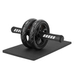 Black ab roller on a black mat with white background