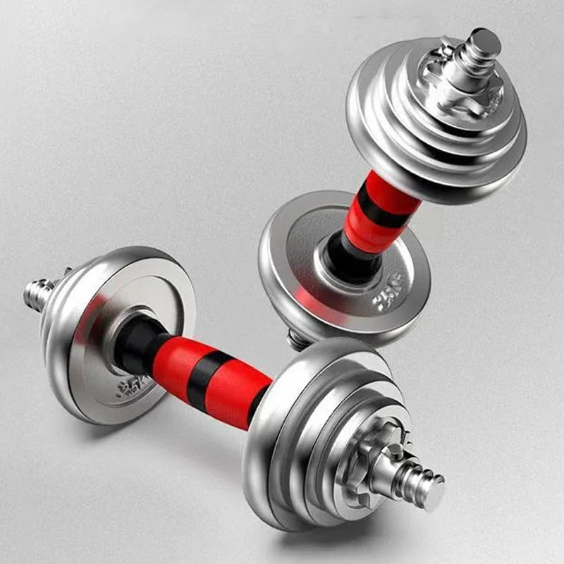 Pair of silver dumbbells with red and black padding on a light gray background