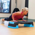 Woman exercising on a step platform in a gym setting