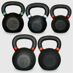 Set of five black kettlebells with labeled weights on a light gray background