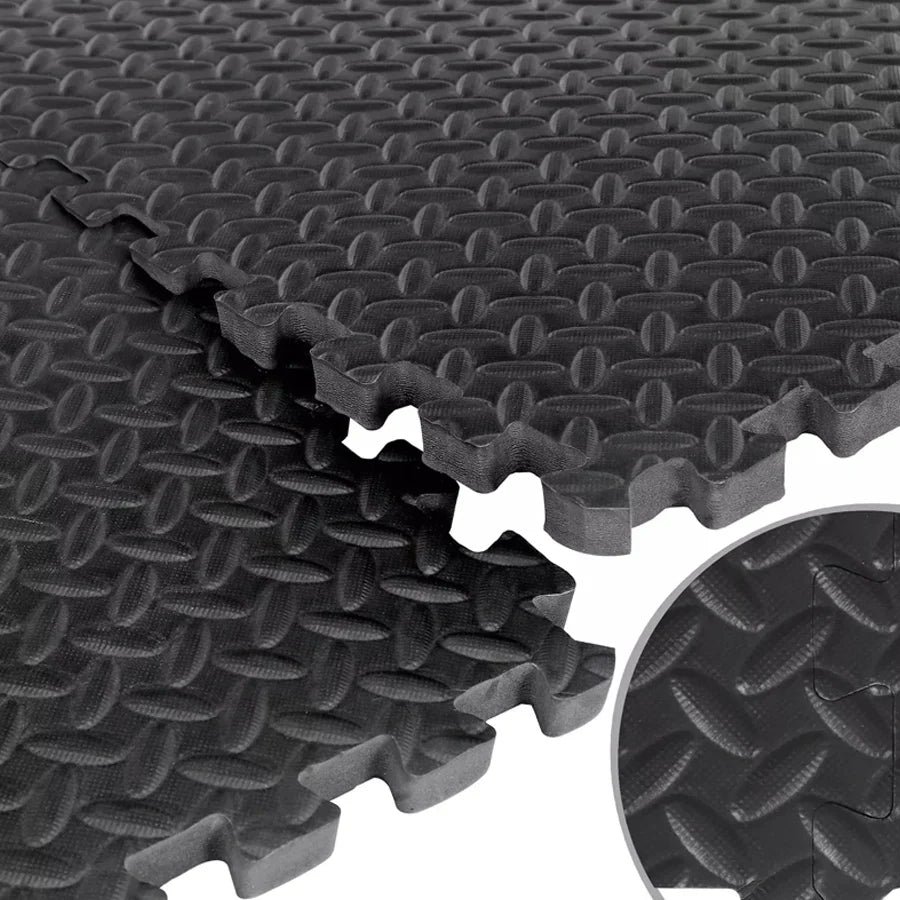 Stack of black interlocking foam mats with textured surface