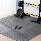 Gym mat with weightlifting equipment in the background