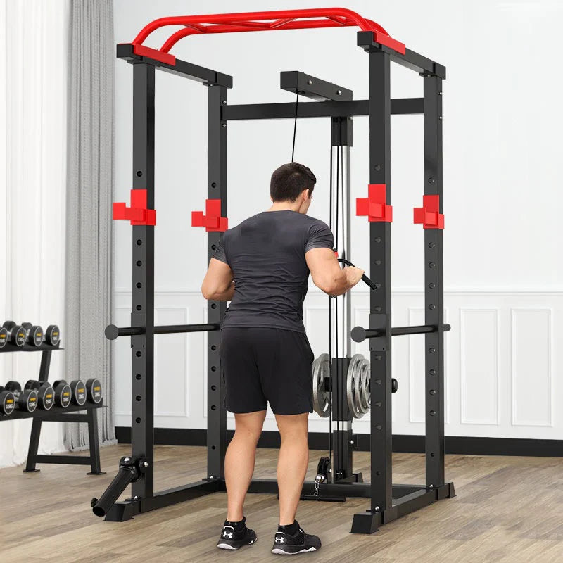 Person using a black and red weightlifting machine in a home gym setting.