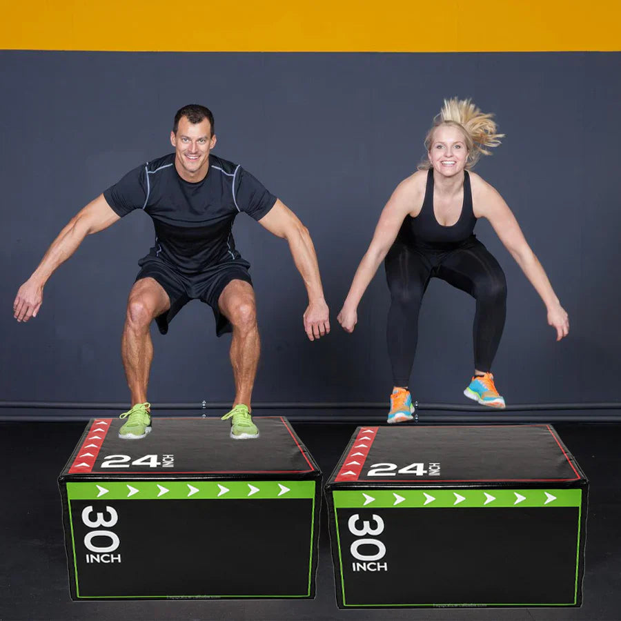 Two people jumping on 30-inch boxes with a dark background
