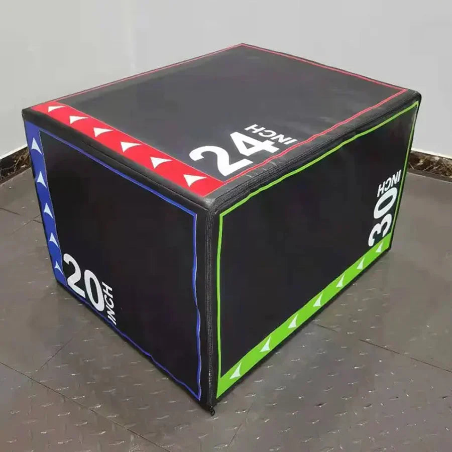 Black exercise cube with colorful side panels and measurement labels on a gray floor.
