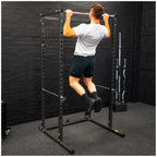Person using a pull-up bar in a home gym setting.