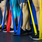 Group of people exercising with resistance bands in a gym setting