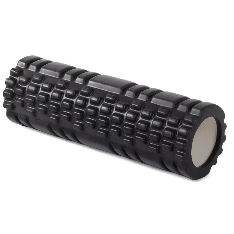 Black foam roller with textured surface on a white background