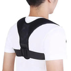 Person wearing a black posture corrector on a white background