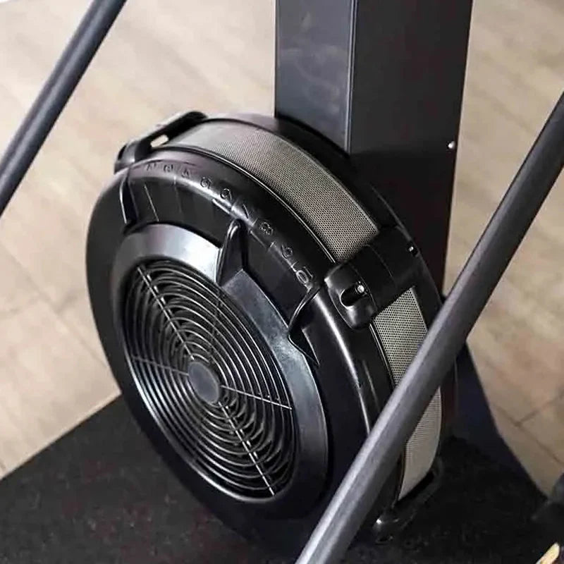 Close-up of a black office chair with a fan on a wooden floor.