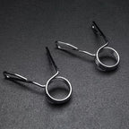 Two metal spring-loaded fishing line holders on a dark gray background