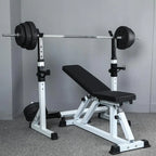 Weight bench with barbell and weights on a gray floor.