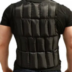 Person wearing a black weighted vest over a black t-shirt on a white background