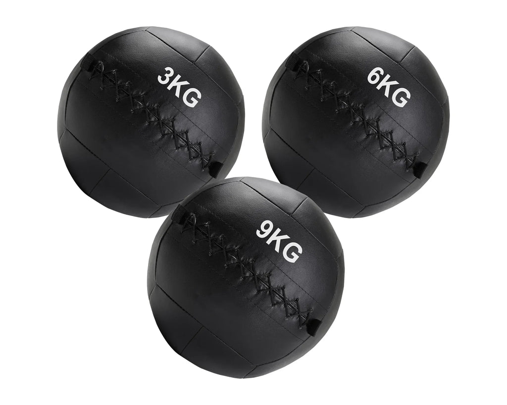 Three black weighted medicine balls with different weights on a white background