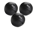 Three black weighted medicine balls with different weights on a white background