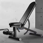 Black adjustable weight bench against a gray concrete wall.