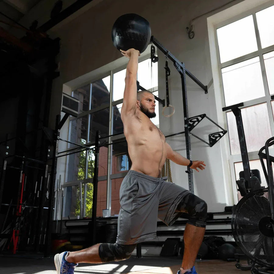 Man exercising with a medicine ball in a gym setting